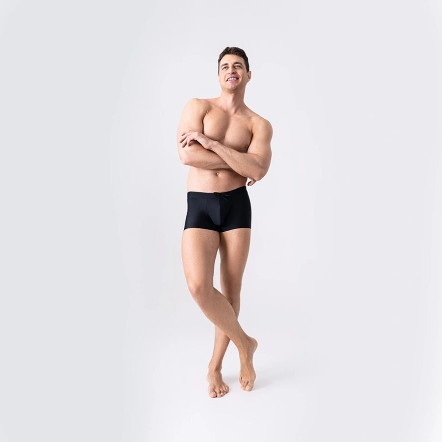 Black anatomical swim trunks for men by Man’s SET, breathable quick-dry fabric, front angle view