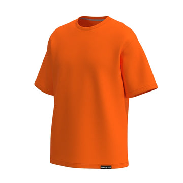 Bright orange oversized cotton tee by Man’s SET, loose fit with dropped shoulders, angled front view
