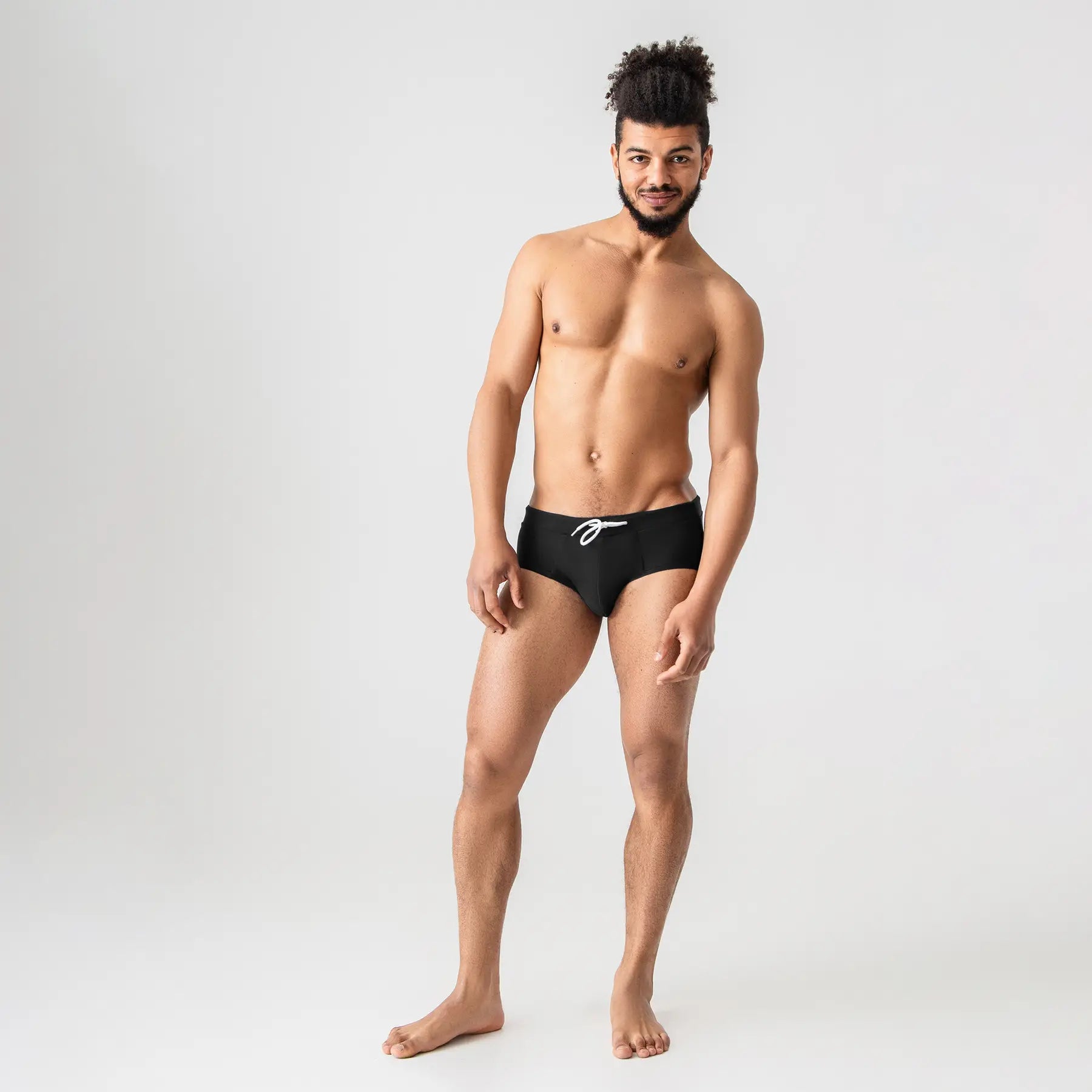 Black swim briefs with drawstring by Man’s SET, comfortable swimwear, front view on model