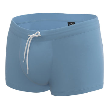 Light gray anatomical men’s swim trunks by Man’s SET, supportive pouch design, angled view