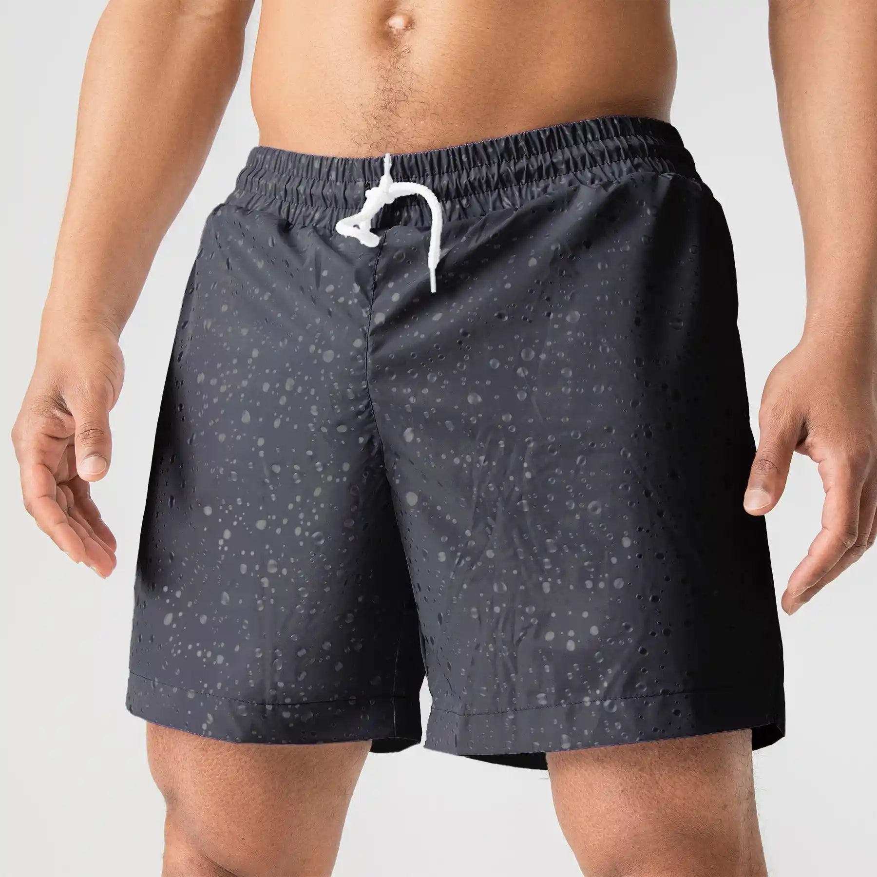 Man’s SET lightweight black swim shorts with water drop print, white drawstring, close-up front view