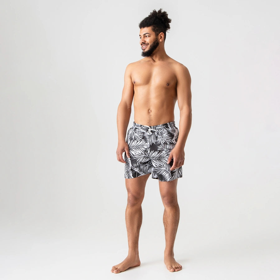Man’s SET Anatomic Shorts 2.0 in black leaf print, lightweight men’s swim trunks with drawstring, front view
