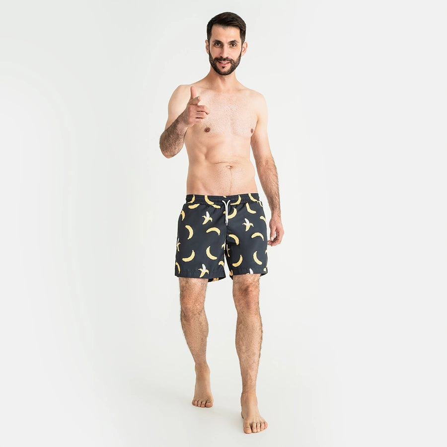 Man’s SET anatomic swim shorts in navy banana print, men’s comfortable swimwear with drawstring waist, front view